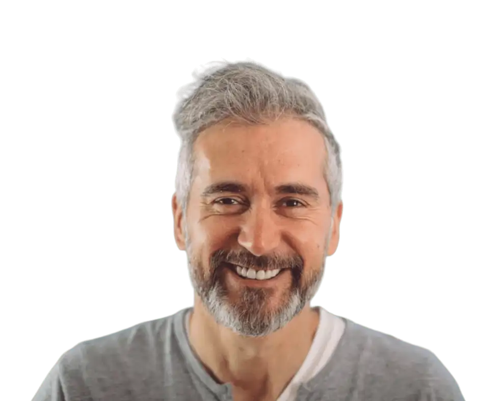 A smiling man with grey hair, possibly after receiving affordable dentures or wisdom teeth extractions.